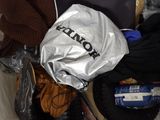 a bag full of clothes and a laptop on a bed