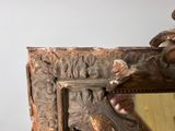a mirror with a bird on it and a mirror with a bird on it