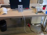 a laptop computer sitting on a desk in front of a window