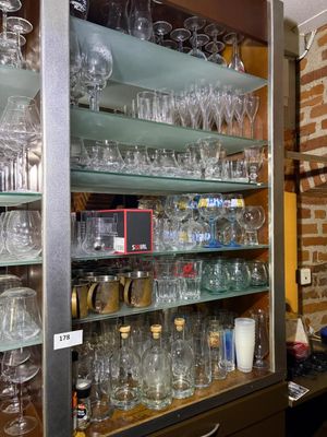 many glasses on the shelves in the room