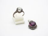 un gros plan sur une bague et une bague sertie d'une pierre violette