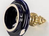 an image of a blue and white vase with a gold ring