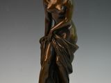 bronze statue of a woman sitting on a marble base