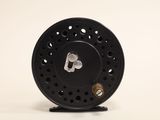 an image of a close up of a fly reel on a white background