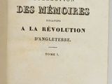 an open book on a white surface with a black and white title