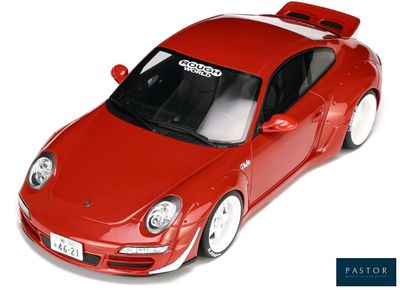a red toy car that is sitting on a white surface