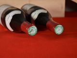 three bottles of wine sitting on a red table