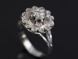 a close up of a diamond ring on a black surface