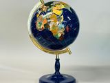 an image of a blue and gold globe sitting on a stand