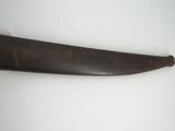 a knife that is laying on a white surface