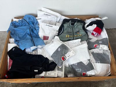 a wooden box filled with clothes and other items