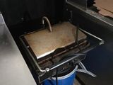 a grill with a pan on top of it in a kitchen