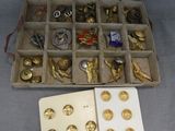 a box with a lot of gold and silver buttons