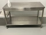 a stainless steel table with a bottle of liquid on it