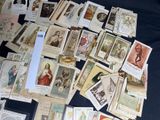 a lot of old religious cards on the table