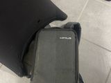 a black bag sitting on the floor next to a black chair