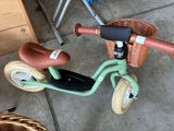 a small child ' s tricycle with a basket on the back
