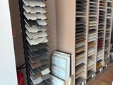 many shelves of tile in a room with a tv