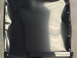 a picture of a piece of black plastic sitting on the ground
