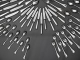 many forks and spoons arranged in the shape of a circle