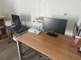 a desk with two monitors and a laptop on it