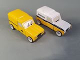 two toy cars sitting next to each other on a table