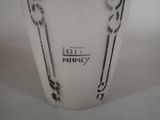 a white vase with a black design on it