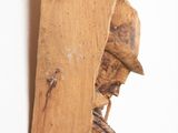 a piece of wood hanging on a wall with a blue cord