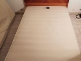 a bed with a wooden headboard and a brown head board