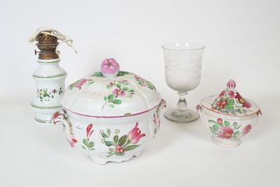 a white table topped with a bowl and a glass