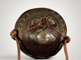 an image of a wooden bowl with a metal handle and a rope around it