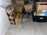two empty wine glasses sitting on the floor next to boxes