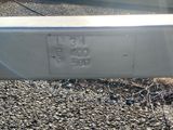 a close up of a metal rail with a number plate on it