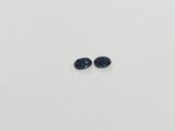 a pair of blue sapphires on a white surface