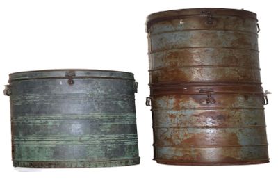 two metal containers sitting next to each other on a white surface