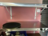 a shelf with a pan on it in a kitchen