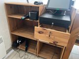 a computer and a printer on a shelf in a room
