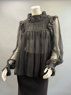 an image of a mannequin wearing a black top and skirt