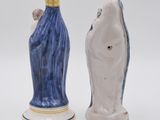 two salt and pepper shakers in the shape of a woman and a man
