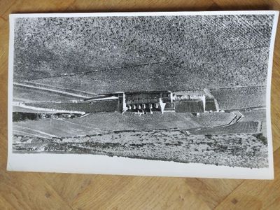 black and white photograph of an old building on a wooden floor