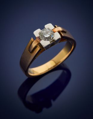 a gold and diamond ring with a single stone in the center