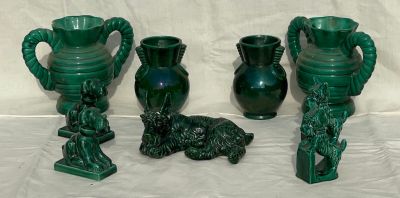three green vases sitting next to each other on a table