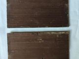 two pieces of chocolate sitting on top of a white sheet