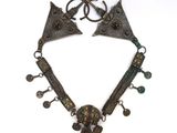 an image of a necklace made of metal with a skull on it