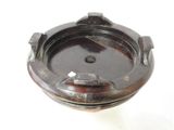 a brown ashtray on a white surface with a white background