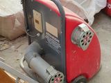 a red and black machine that is sitting on the ground
