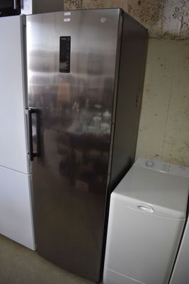 a silver refrigerator and a white washer in a room