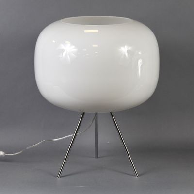 a white lamp that is on a metal stand