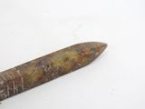 a knife that is laying on a white surface