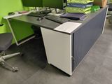a computer desk with two monitors and a keyboard on it